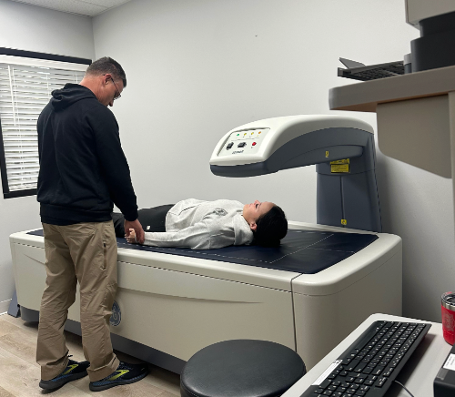 Person preparing a child for a medical scan in a clinical setting