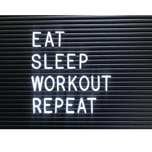 LED sight that says "eat, sleep, workout, repeat"